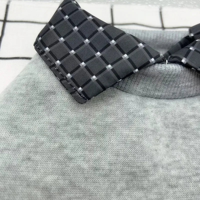 Black checkered tie on a gray fabric background