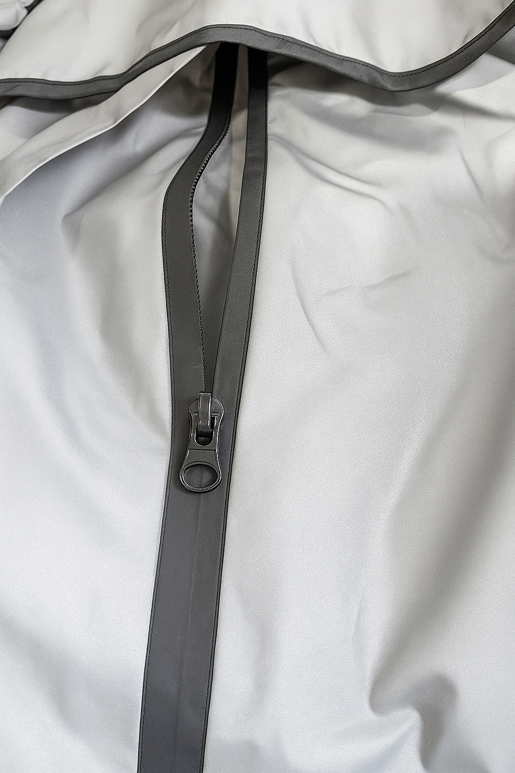 Close-up of a zipper on a light gray jacket