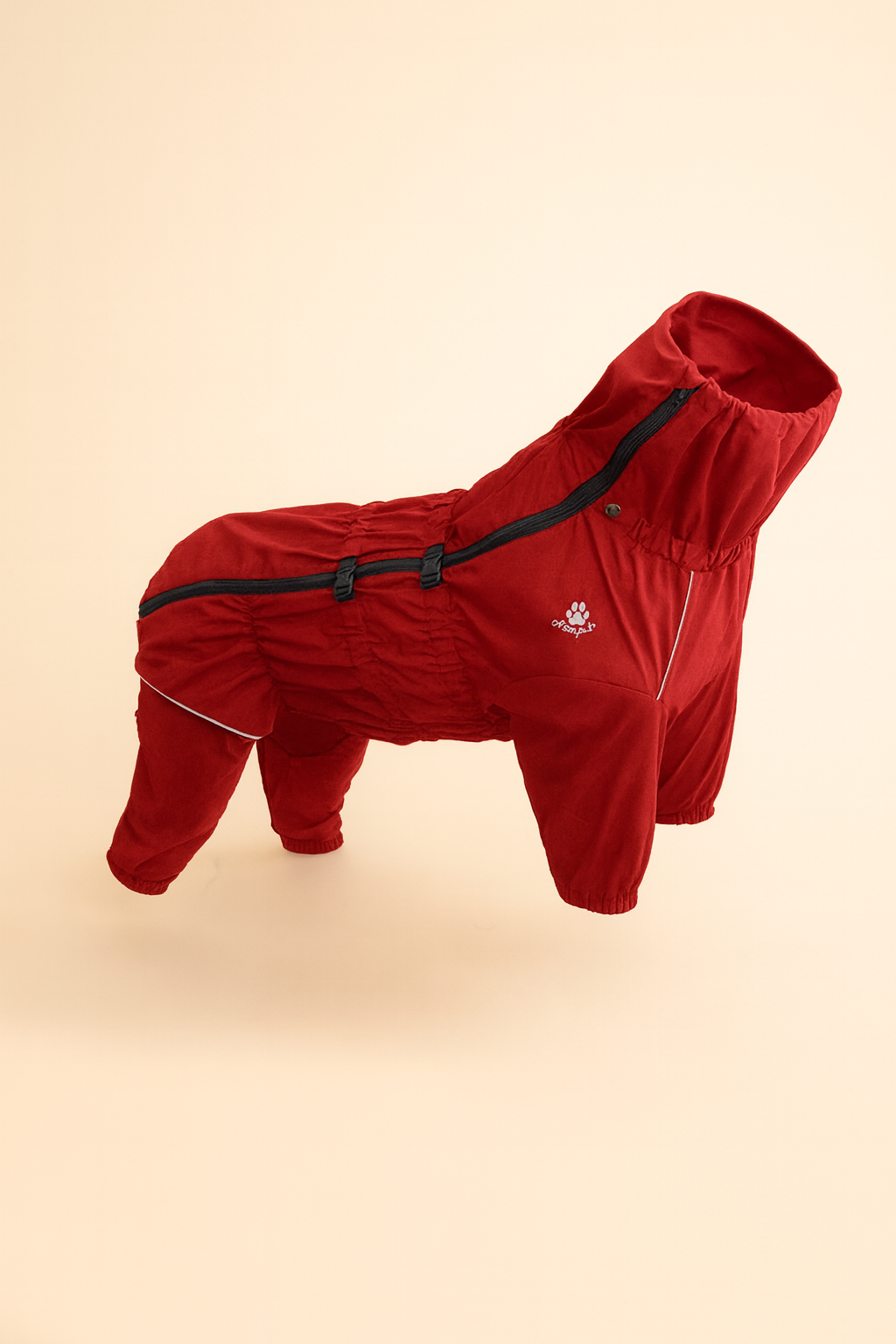 Red dog coat with black trim on a beige background