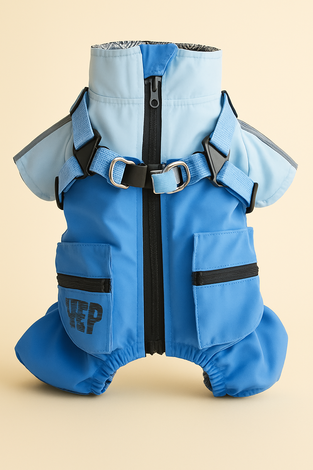 Blue dog raincoat with black zippers and straps on a beige background